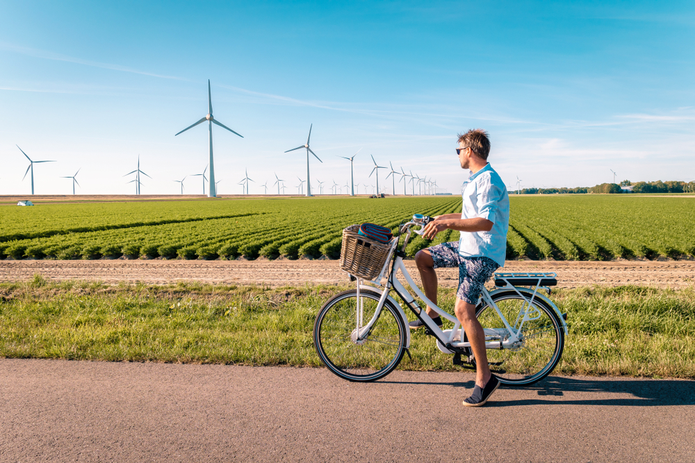 Young,Man,Electric,Green,Bike,Bicycle,By,Windmill,Farm,,